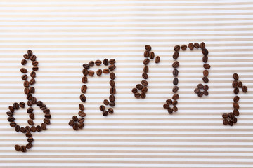 Treble clef and musical notes of coffee beans on striped background