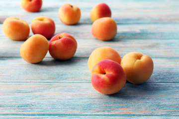 Ripe apricots on wooden table close up