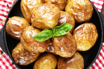 Baked potatoes in pan, closeup