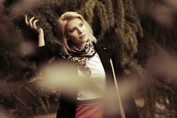 Happy young fashion woman walking in autumn park