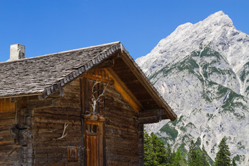 Rural Scene wit Mountain Range and old Alpine Hut