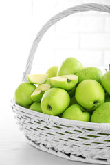 Green apples in wicker basket, closeup