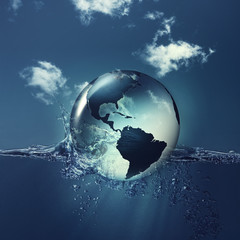 Save the planet. Earth globe on the water waves, abstract natura