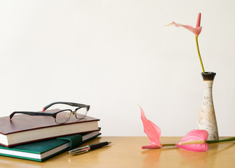Composition on desk with books and flowers on white background