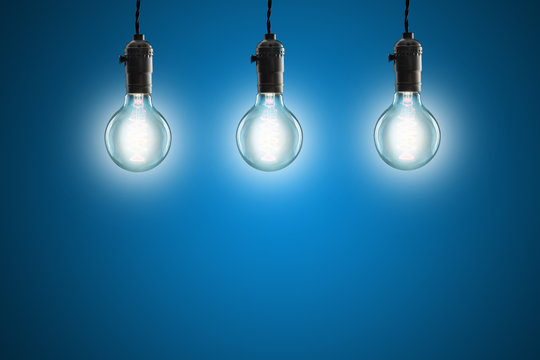 Idea concept - Vintage incandescent bulbs on blue background