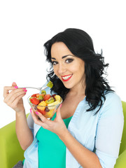 Young Woman Eating a Fresh Fruit Salad