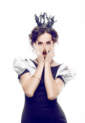 Studio portrait of a beautiful brunette with a crown