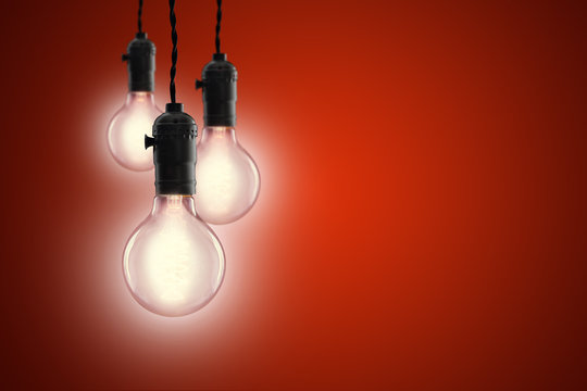 Idea concept - Vintage incandescent bulbs on red background