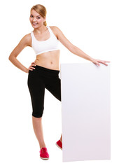 Fitness sporty woman holding blank empty ad banner