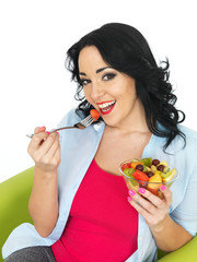 Young Woman Eating a Fresh Fruit Salad