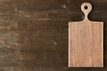 Cutting board on wooden background