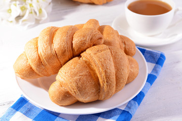 Delicious croissants on plate on table close-up