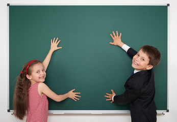 boy and girl write on school board