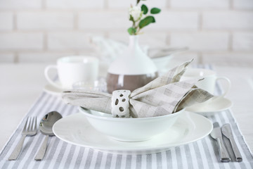 Beautiful holiday table setting in white and gray color