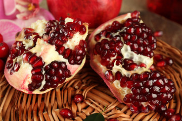 Pomegranate seeds on wicker tray, closeup