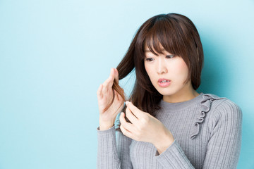 attractive asian woman hair care image on blue background