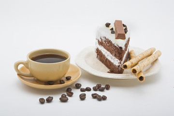 cup of coffee and delicious cake on white background