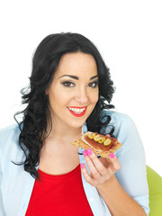 Young Woman Eating a Cracker with Parma Ham and Sliced Green Olives