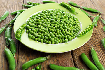 Fresh green peas in bowl on table close up
