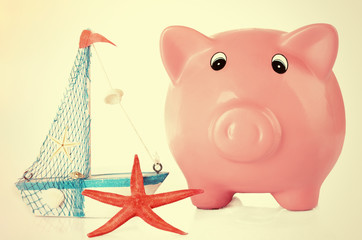 Piggy bank with nautilus and sea star on light background