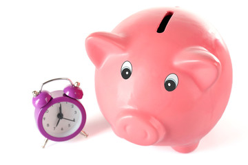 Piggy bank with alarm clock isolated on white