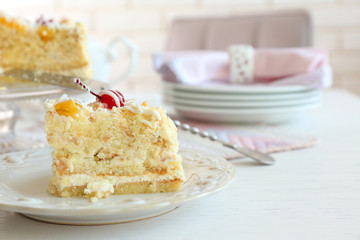 Peace of tasty Butter cake on plate, on color wooden background