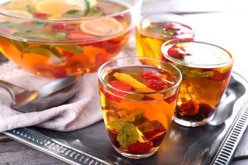 Fruity punch in glassware on metal tray, closeup