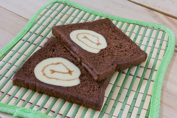 sliced chocolate bread with jam roll cakes