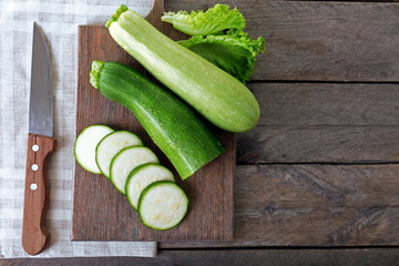 Fresh zucchini with squash on cutting board