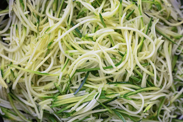 Grated zucchini and squash in pan close up