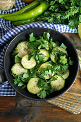 Sliced zucchini in pan on table, top view