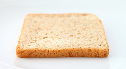Sliced bread on white plate.