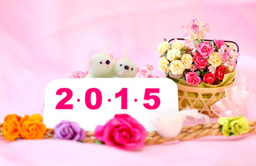 Bears candle on the 2015 New year flower background with clippin