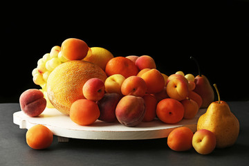Heap of fresh fruits on dark background