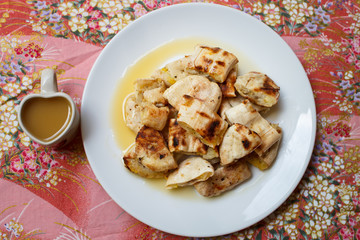 Grilled banana serve with syrup.