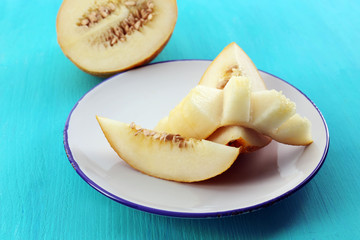 Slices of ripe melon on wooden table close up