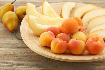 Naklejka na ściany i meble Heap of fresh fruits on wooden table close up