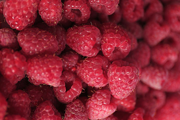 Heap of sweet red raspberries close up