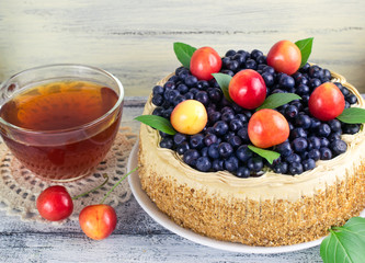 Celebratory cake with blueberries, sweet cherry, mint leaves and