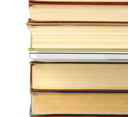 Stack of books with laptop close up