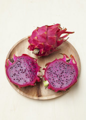 Closeup Red Dragon fruit on wooden plate 