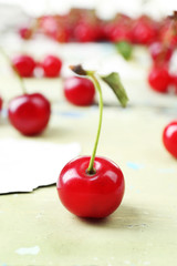 Fresh cherries on cracked wooden table, closeup