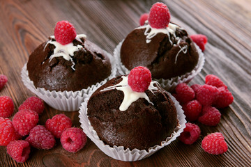 Delicious cupcakes with berries on table close up