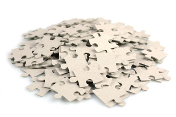 Pile of puzzle pieces isolated on white