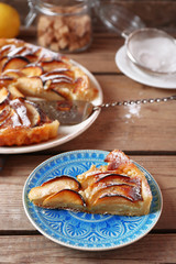 Piece of homemade apple pie on wooden background
