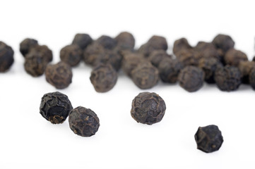 Black pepper seeds on white background