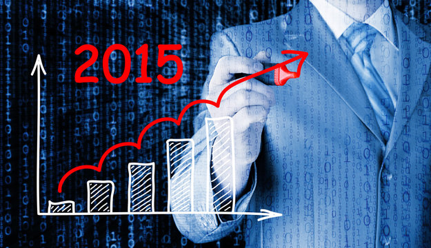 business man drawing growth graph for year 2015