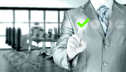 business man touching, pressing modern button with green ticking