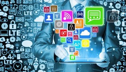 Business man using tablet PC with social media icon set