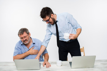 The two colleagues working together at office on white